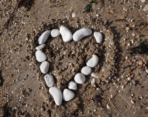 Heart made from stones on sand